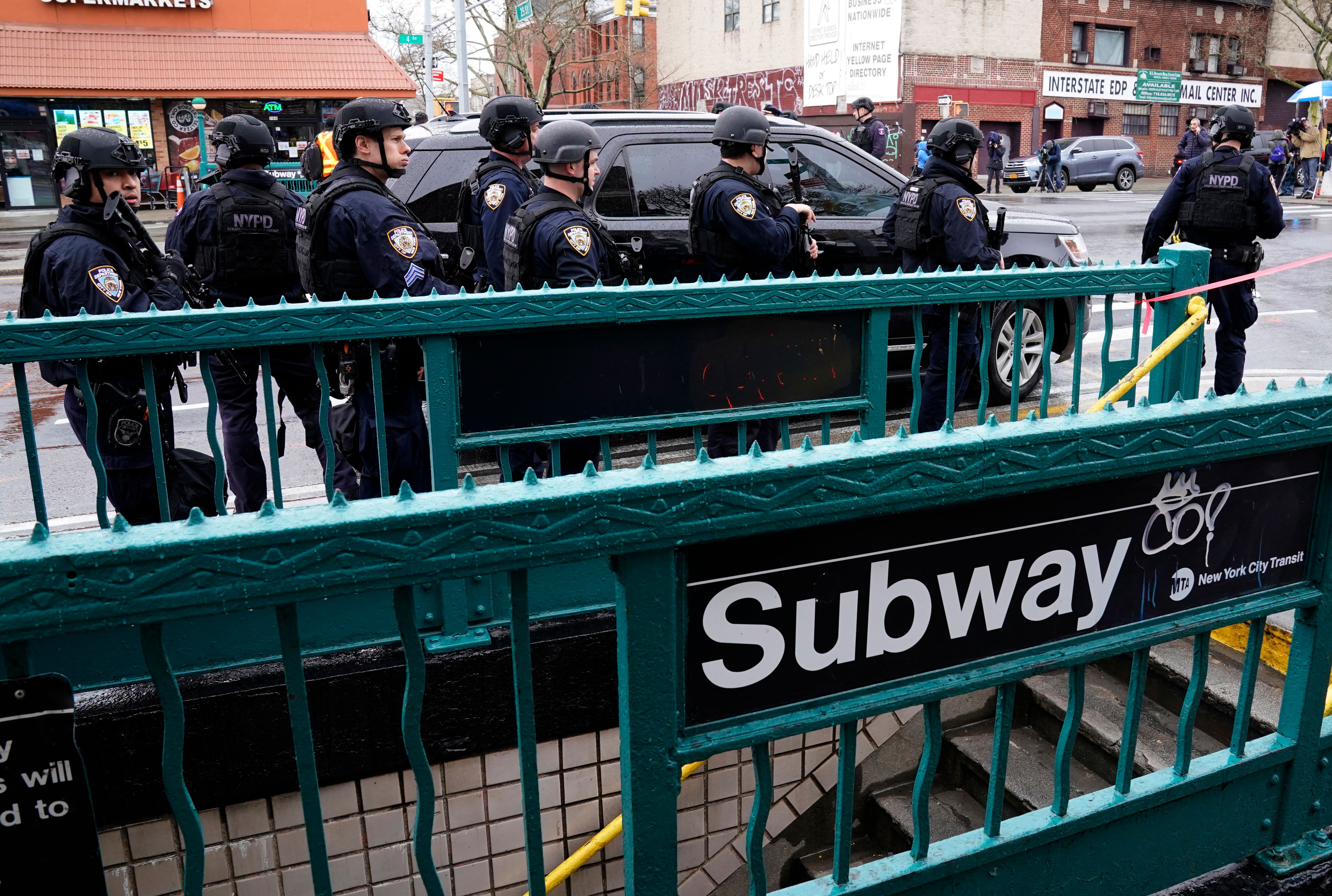 Members of the New York Police Department patrol the streets after at least 13 people were injured during a rush-hour shooting at a subway station in the New York borough of Brooklyn on April 12, 2022, where authorities said “several undetonated devices” were recovered amid chaotic scenes. – Ambulances lined the street outside the 36th Street subway station, where a New York police spokeswoman told AFP officers responded to a 911 call of a person shot at 8:27 am (1227 GMT). The suspect was still at large, according to Manhattan borough president Mark Levine. (Photo by TIMOTHY A. CLARY / AFP) (Photo by TIMOTHY A. CLARY/AFP via Getty Images)