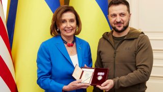 Ukrainian President Volodymyr Zelenskyy, right, awards the Order of Princess Olga, the third grade, to U.S. Speaker of the House Nancy Pelosi in Kyiv, Ukraine, Saturday, April 30, 2022.