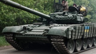 Ukrainian soldiers stand on a multipurpose light armoured towing vehicle near Bakhmut, eastern Ukraine, on May 15, 2022, amid the Russian invasion of Ukraine.