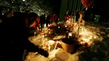 Students gather around a makeshift memorial Friday, Feb. 15, 2008 after a campus vigil on Northern Illinois University campus in DeKalb, Ill. (AP Photo/Nam Y. Huh)