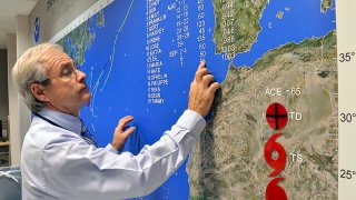 Meteorologist Dennis Feltgen places the wind speed of Nate on a tracking map at the National Weather Service’s National Hurricane Center at Florida International University in Miami, Florida, U.S., on Thursday, Sept. 8, 2011. Nate weakened as the storm moved over Mexico with heavy rains and has been downgraded to a post-tropical system, the National Hurricane Center said. Photographer: Mark Elias/Bloomberg via Getty Images