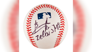 This image provided by RR Auction shows a baseball signed by Ukrainian President Volodymyr Zelenskyy.