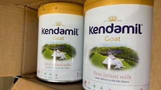 Two cans of Kendamil Goat First Infant Milk Stage 1 in a cardboard shipping box.