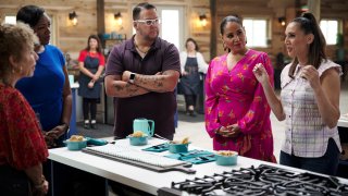 Judges Tiffany Derry, from second left, Graham Elliot, host Alejandra Ramos and judge Leah Cohen gather around d a contestant’s station in a scene from the competition series "The Great American Recipe."