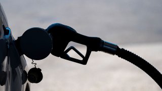 A fuel pump nozzle in a vehicle at a gas station.