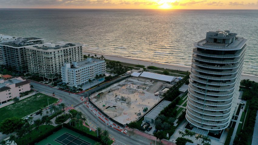 SURFSIDE, FLORIDA – JUNE 22:  In an aerial view, a cleared lot where the 12-story Champlain Towers South condo building once stood is seen on June 22, 2022 in Surfside, Florida. This week marks the first anniversary of the tragic event where 98 people died when the building partially collapsed on June 24, 2021. (Photo by Joe Raedle/Getty Images)