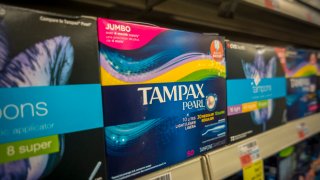Packages of Tampax brand tampons on a drugstore shelf