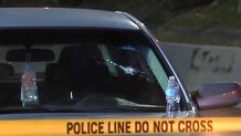 A woman was injured when two cars were shooting at each other on I-95 in Miami-Dade.