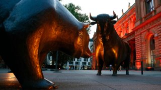 A bull and a bear statue stand outside the Frankfurt Stock Exchange in Frankfurt.