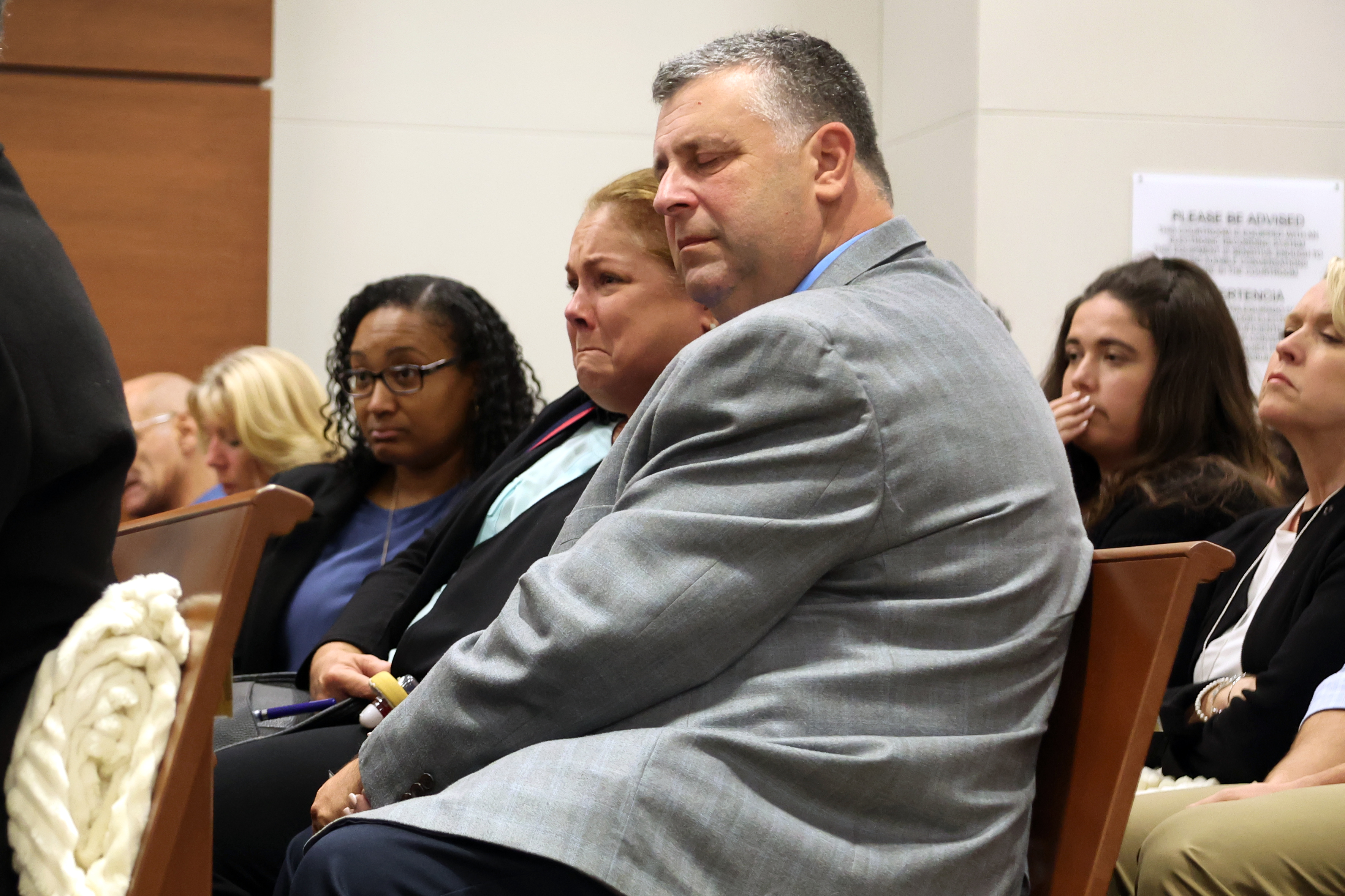 Jennifer and Tony Montalto listen to Dr. Marlin Osbourne, Assistant Medical Examiner for Palm Beach county testify about the gunshot wounds their daughter Gina Montalto sustained in the mass shooting.