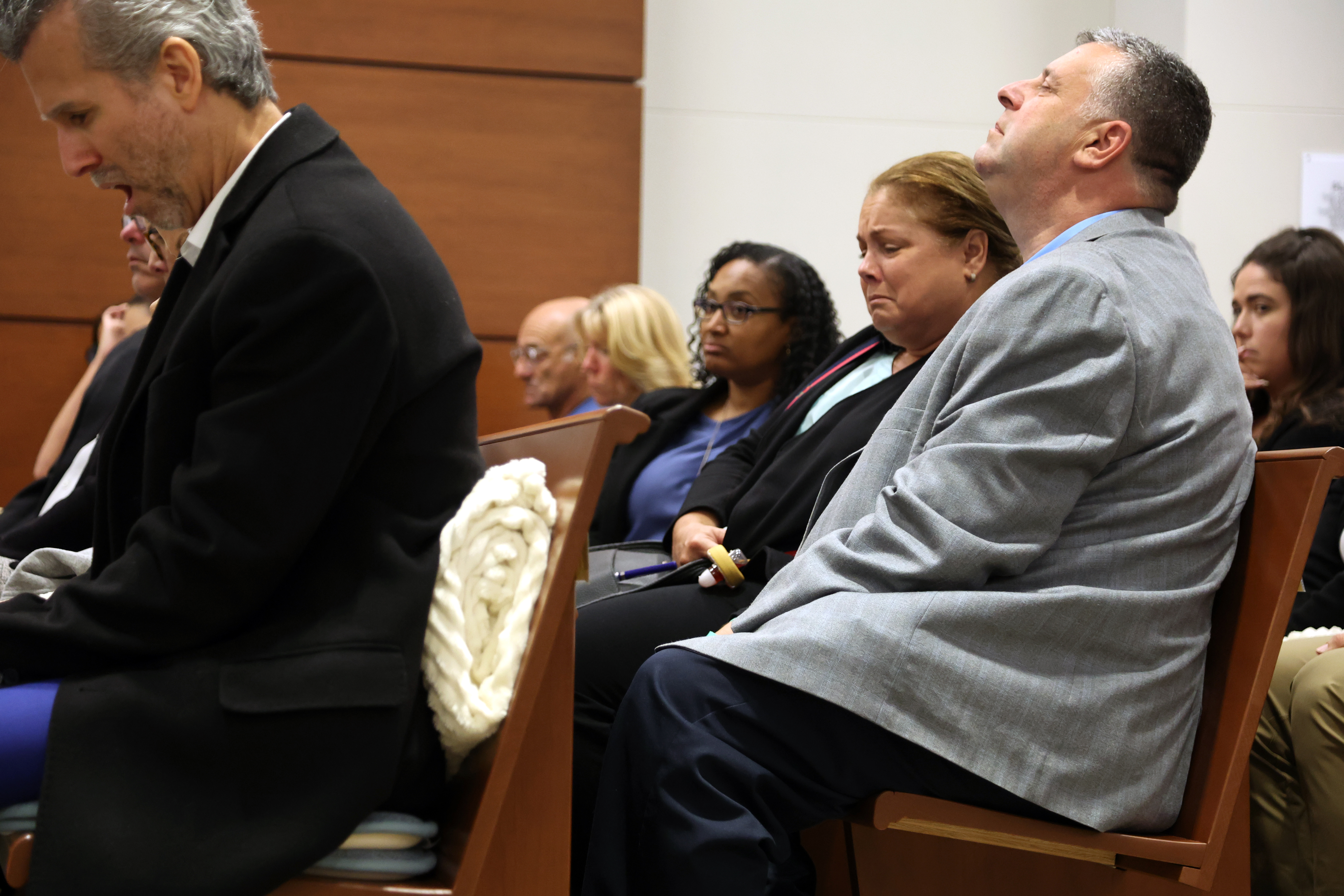 Jennifer and Tony Montalto listen to Dr. Marlin Osbourne, Assistant Medical Examiner for Palm Beach county testify about the gunshot wounds their daughter Gina Montalto sustained in the mass shooting.