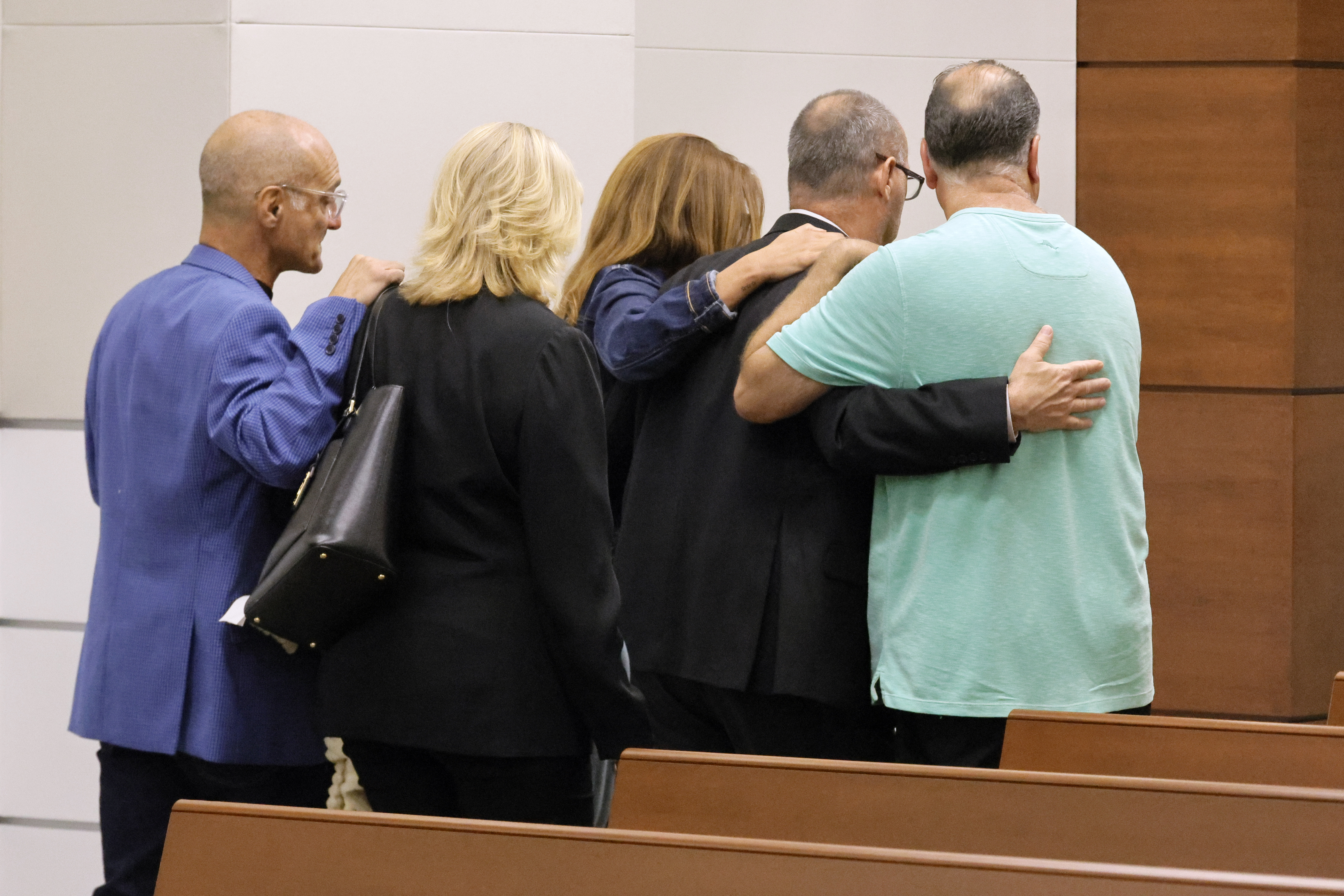 Parents and friends of the victims of the mass shooting leave the courtroom.
