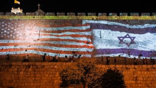 Israeli authorities project an image of the Israeli and U.S. flags on the walls of Jerusalem's Old City
