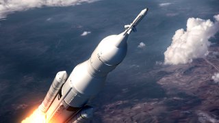Space Launch System Flying Over The Clouds.
