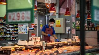 A vendor cuts meat at a supermarket in Beijing, China, on Thursday, Aug. 4, 2022. China is scheduled to release consumer price index (CPI) figures on Aug. 10. Source: Bloomberg