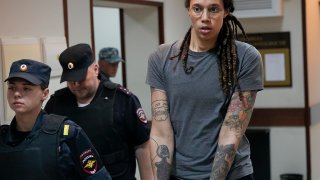 Brittney Griner is escorted from a court room after a hearing