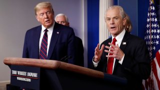 White House trade adviser Peter Navarro, who will now serve as national defense production act policy coordinator, speaks about the coronavirus in the James Brady Press Briefing Room, Friday, March 27, 2020, in Washington, as President Donald Trump listens.