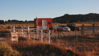 File - The entrance to a film set where police say actor Alec Baldwin fired a prop gun, killing a cinematographer, is seen outside Santa Fe, New Mexico, Friday, Oct. 22, 2021.