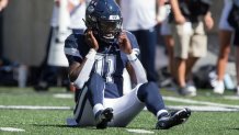 LOGAN, UT- AUGUST 27: Zion Turner #11 of the Connecticut Huskies sits on the turf after being tackled by the Utah State Aggies during the first half of their game on August 27, 2022 at Maverik Stadium in Logan, Utah. (Photo by Chris Gardner/Getty Images)