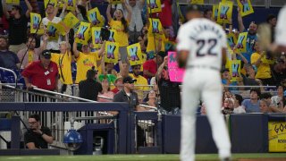 MIAMI, FLORIDA – AUGUST 03: Fans hold up K signs as Sandy Alcantara #22 of the Miami Marlins walks off the field after striking out Michael Papierski #26 of the Cincinnati Reds in the fifth inning at loanDepot park on August 03, 2022 in Miami, Florida. (Photo by Eric Espada/Getty Images)