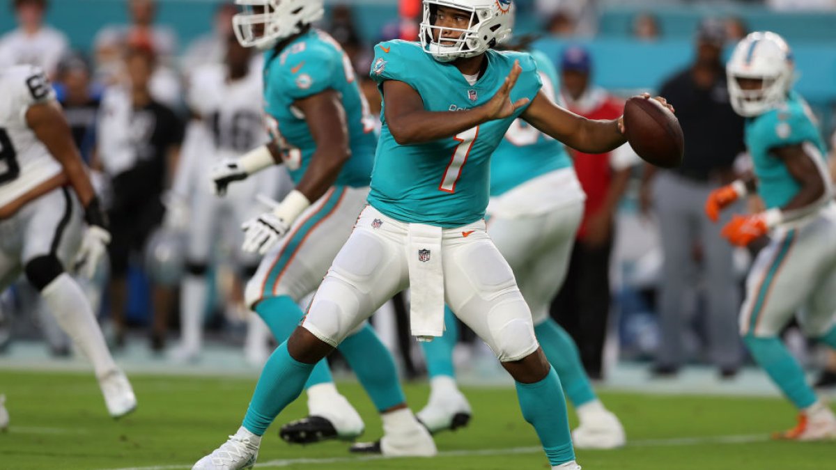 Miami Dolphins quarterback Skylar Thompson (19), wide receiver Jaylen Waddle  (17) and Tyreek Hill (10) talk on the field during the first half of an NFL  football game against the New York