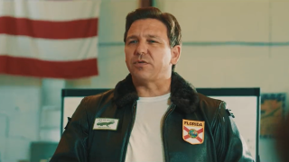 Photo shows Florida Gov. Ron DeSantis sitting in a newly released Top Gun-themed ad that takes aim the “corporate media.”