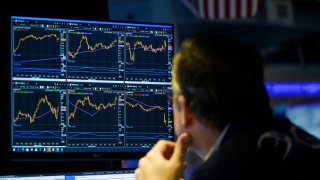 Traders work during the opening bell at the New York Stock Exchange (NYSE) on Wall Street in New York City on August 16, 2022.