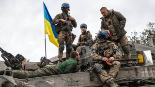 A Russian soldier, taken prisoner, on a tank with Ukrainian soldiers after the city was recaptured from Russian forces on September 11,2022 in Izyum, Ukraine. A Ukrainian counteroffensive has made significant advances in the east of Ukraine taking back land that have been under Russian control.