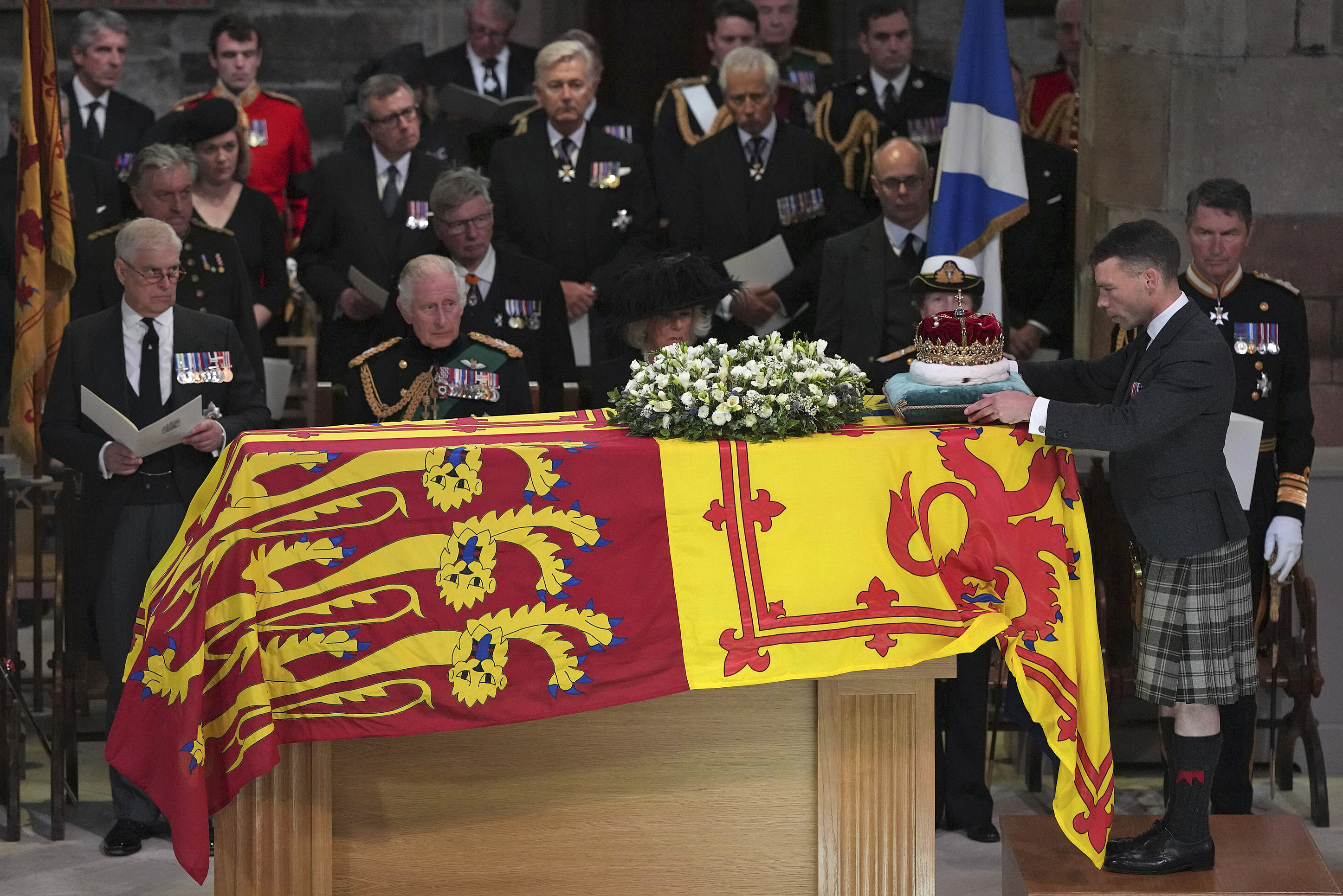 From left, Prince Andrew, King Charles III, Camilla, the Queen Consort, Princess Anne and Vice Admiral Sir Tim Laurence, look on as the Duke of Hamilton places the Crown of Scotland on the coffin during the Service of Prayer and Reflection for the Life of Queen Elizabeth II at St Giles’ Cathedral, Edinburgh, Sept. 12, 2022.