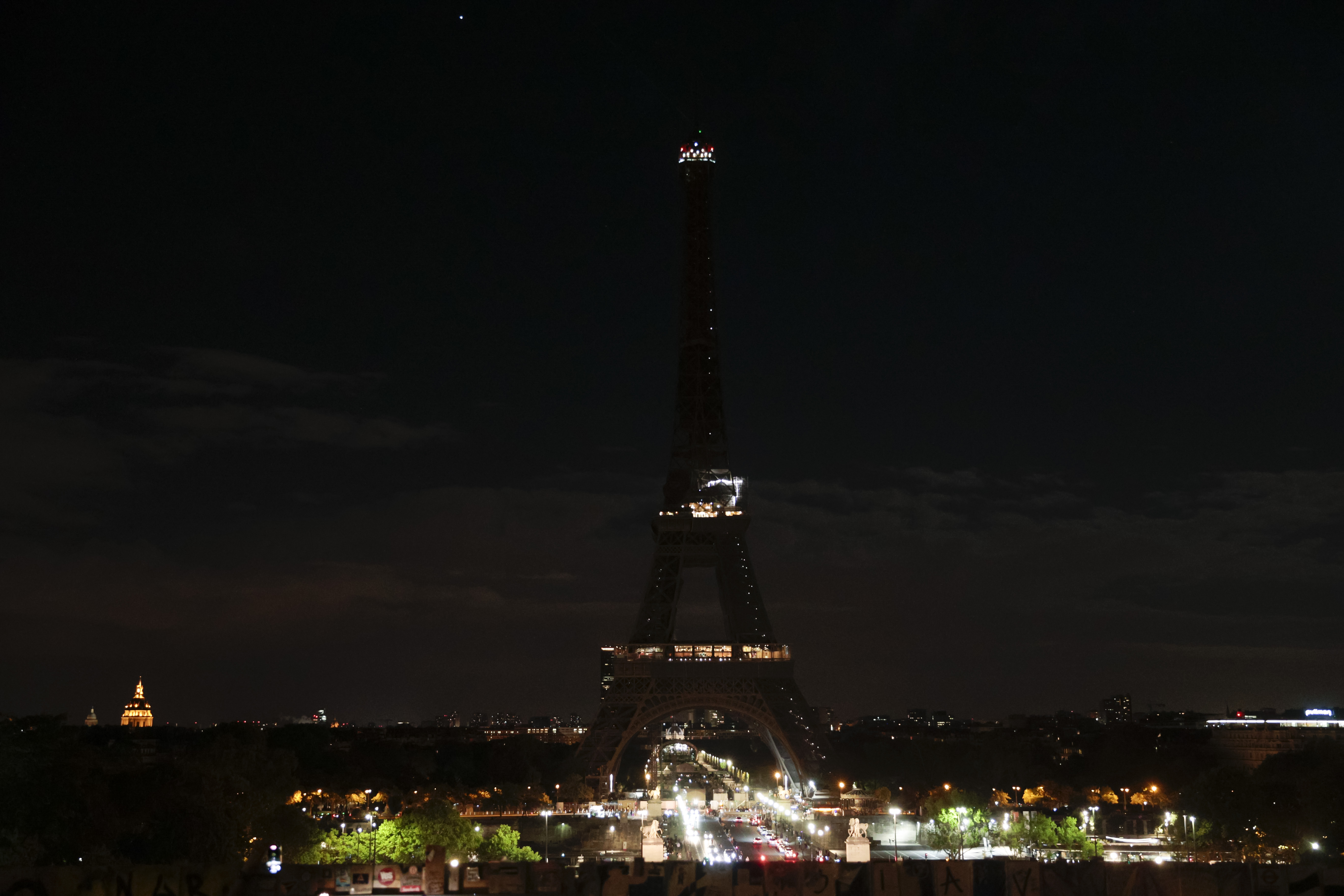 The lights of the Eiffel tower are turned off in memory of Queen Elizabeth II, Sept. 8, 2022 in Paris, France.