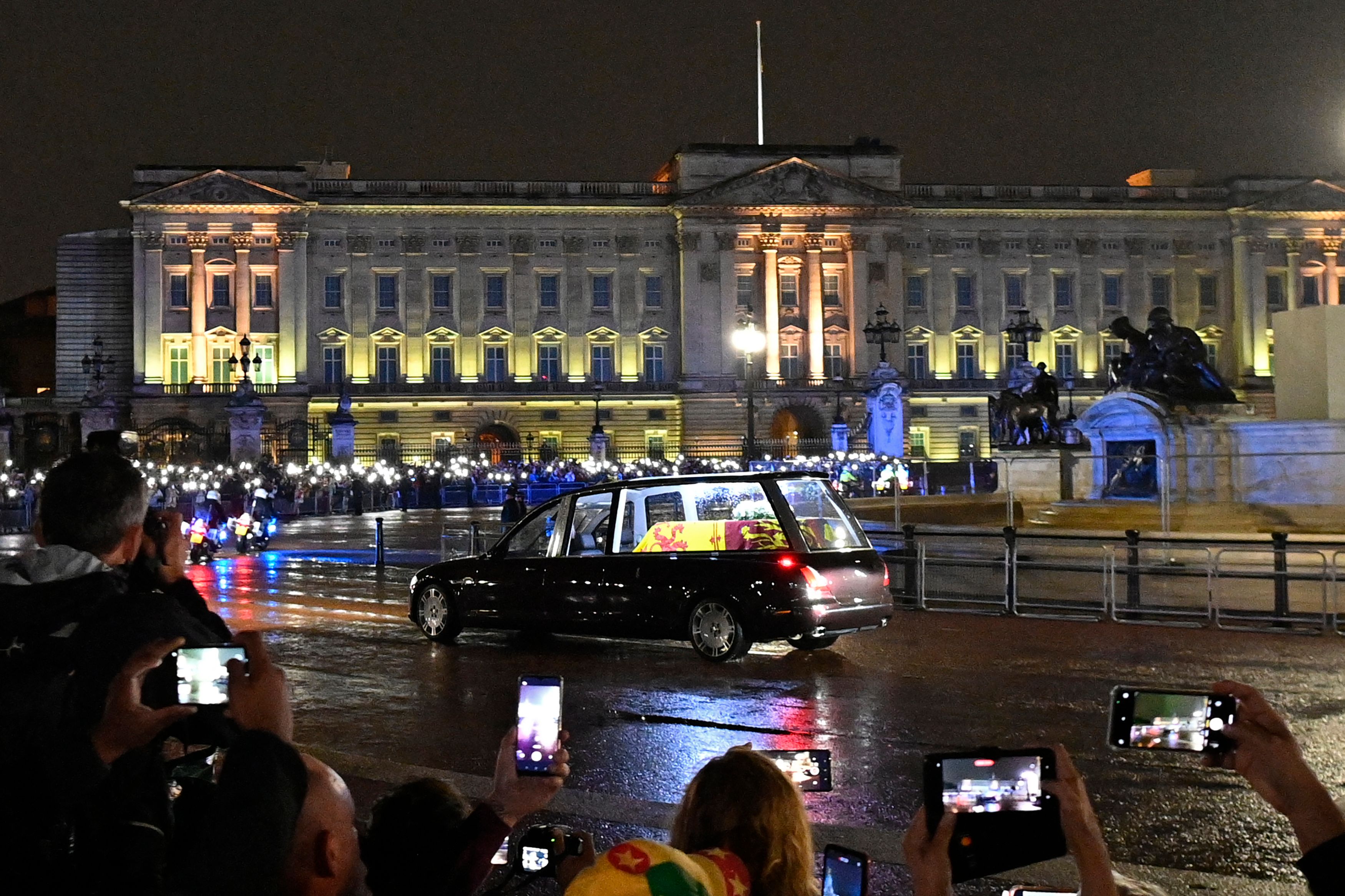 The coffin of Queen Elizabeth II arrives in the Royal Hearse at Buckingham Palace in London on September 13, 2022, where it will rest in the Palace’s Bow Room overnight.