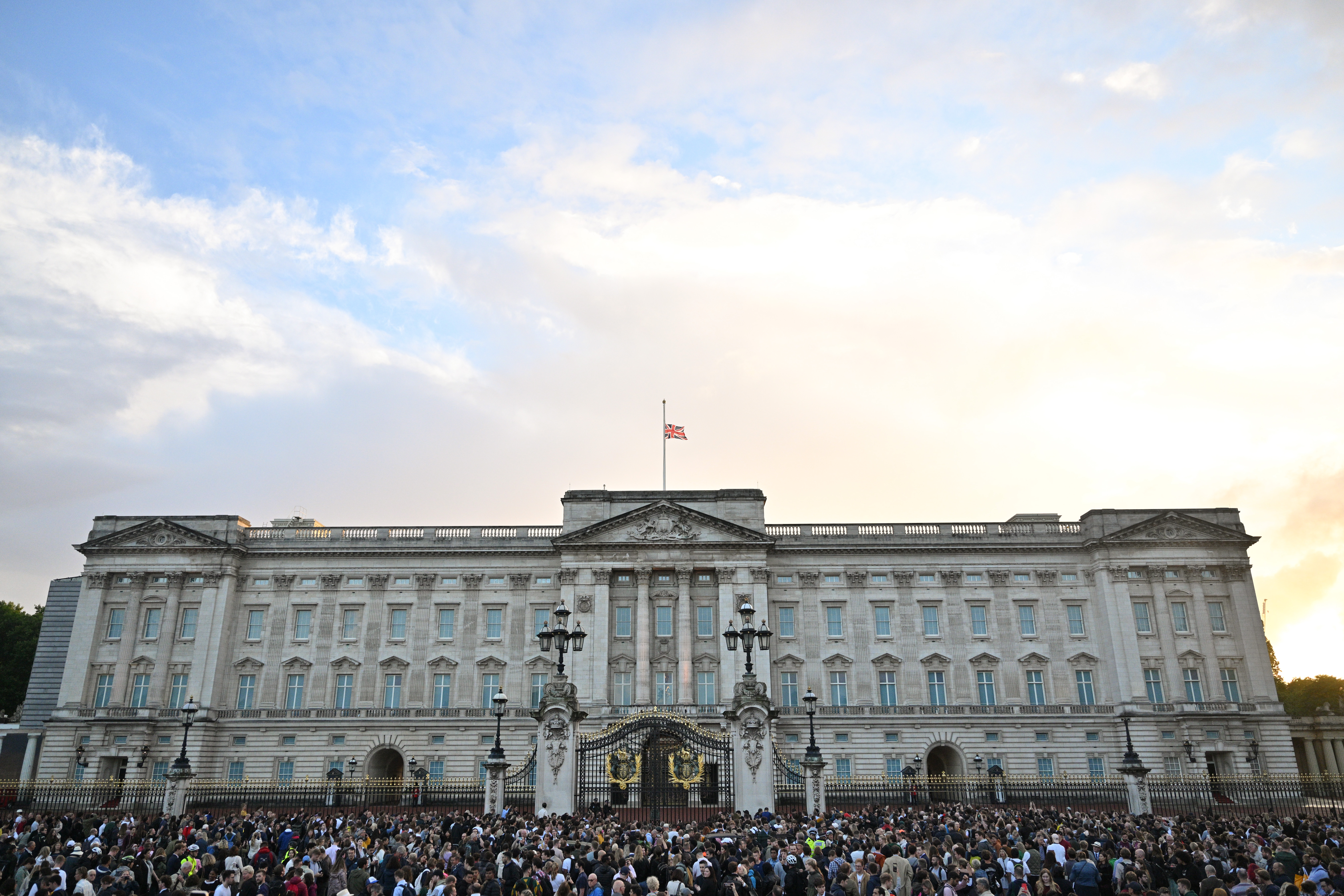 The Union flag flies half mast as people gather at Buckingham Palace on Sept. 8, 2022 in London, England following the death of Queen Elizabeth II.