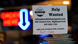 FILE - Hiring sign is displayed at a restaurant in Highland Park, Ill., July 14, 2022.