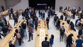 Customers shop at the Apple Fifth Avenue store for the release of the Apple iPhone 14 in New York City, September 16, 2022.