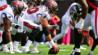 TAMPA, FLORIDA – OCTOBER 09: Robert Hainsey #70 of the Tampa Bay Buccaneers snaps the ball during the second quarter of the game against the Atlanta Falcons at Raymond James Stadium on October 09, 2022 in Tampa, Florida. (Photo by Julio Aguilar/Getty Images)