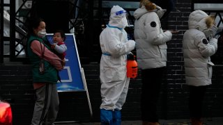 Residents line up for COVID-19 tests in Beijing, Saturday, Nov. 26, 2022.