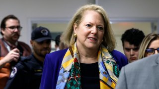 Virginia Thomas leaves for a break during a closed-door meeting