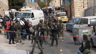 An Israeli policeman secures a shooting attack site in east Jerusalem, Saturday, Jan. 28, 2023.