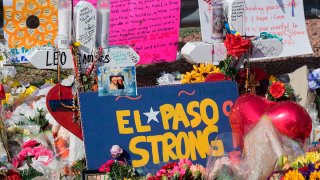 FILE - Signs and flowers adorn the makeshift memorial for victims of the shooting that left a total of 22 people dead at the Cielo Vista Mall Walmart, in El Paso, Texas, on Aug. 7, 2019.
