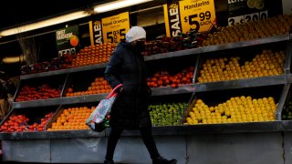 A woman walks past a grocery store on February 01, 2023 in New York City. Wages for workers in most major U.S. cities grew at a slower pace in the final three months of 2022, with inflation still outstripping pay for many workers.