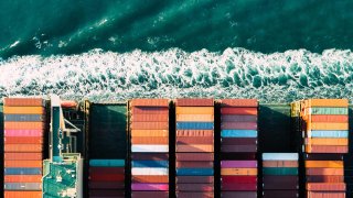 An aerial daytime view of a container ship on The Solent Sea, U.K.