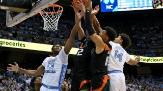 CHAPEL HILL, NORTH CAROLINA – FEBRUARY 13: Jalen Washington #13 and Puff Johnson #14 of the North Carolina Tar Heels battle Isaiah Wong #2 and Jordan Miller #11 of the Miami Hurricanes for a rebound during the first half of their game at the Dean E. Smith Center on February 13, 2023 in Chapel Hill, North Carolina. (Photo by Grant Halverson/Getty Images)