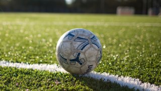 Photo of a soccer ball against a field