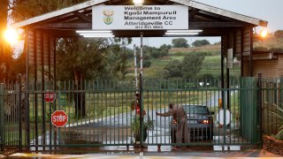 Correctional Services Officer closes the gate at the Atteridgeville Correctional Centre in Pretoria