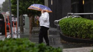 A woman walks in the rain in Miami, Florida, the United States, Sept. 27, 2022. A hurricane warning has been extended southward on the west coast of the U.S. state of Florida to Chokoloskee, forecasters said Tuesday evening. (Photo by Monica McGivern/Xinhua via Getty Images)