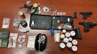 Two men and a woman were arrested after authorities found a stash of drugs and guns in a car during a traffic stop in the Florida Keys, officials said.