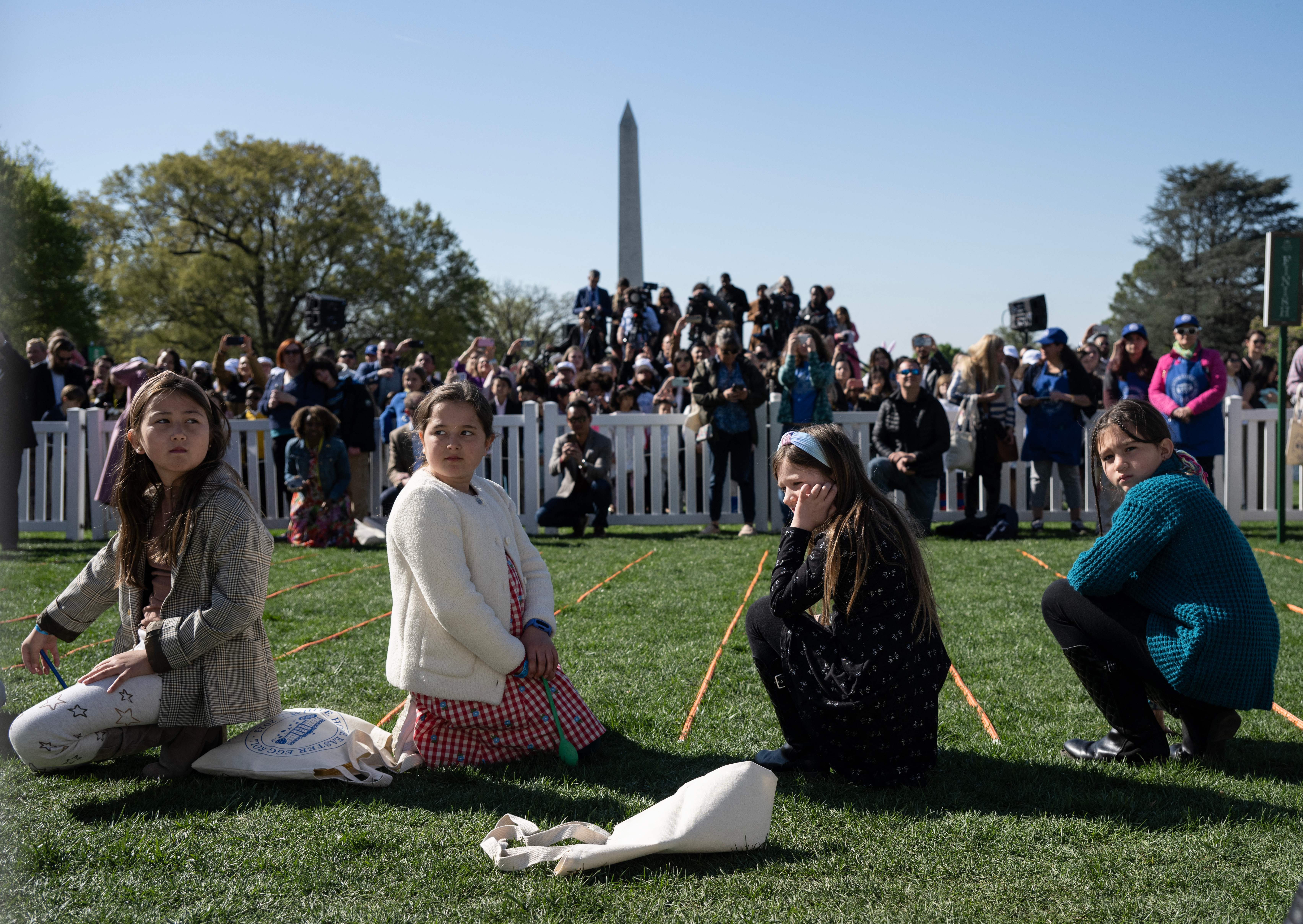 People wait for the arrival of President Joe Biden and first lady Jill Biden at the annual Easter Egg Roll on the South Lawn of the White House in Washington, D.C, April 10, 2023.