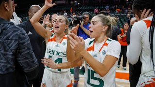 Miami Hurricanes guard Haley Cavinder (14) and guard Hanna Cavinder (15) celebrate after the Canes defeat Florida State Seminoles at the Watsco Center on Feb. 9, 2023, in Coral Gables, Florida. (Al Diaz/Miami Herald/Tribune News Service via Getty Images)