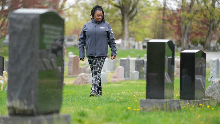 Debra Long walks near the tombstone of her son, Randy Long, in Poughkeepsie, N.Y., April 19, 2023.