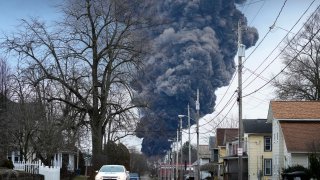 A black plume rises over East Palestine, Ohio, as a result of a controlled detonation of a portion of the derailed Norfolk Southern trains, on Feb. 6, 2023.